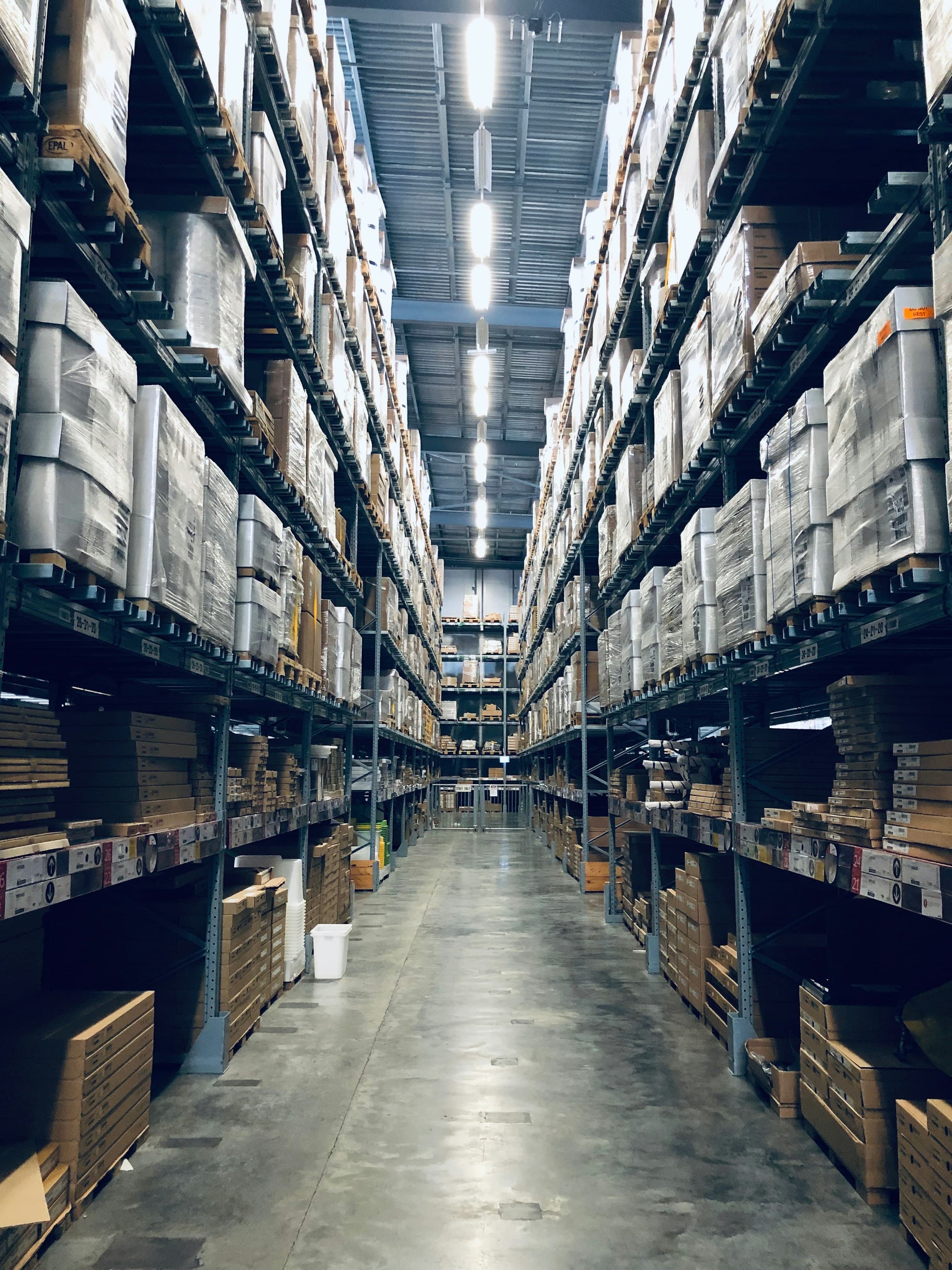 Clean, organized warehouse interior with high-bay racking and professional logistics operations.