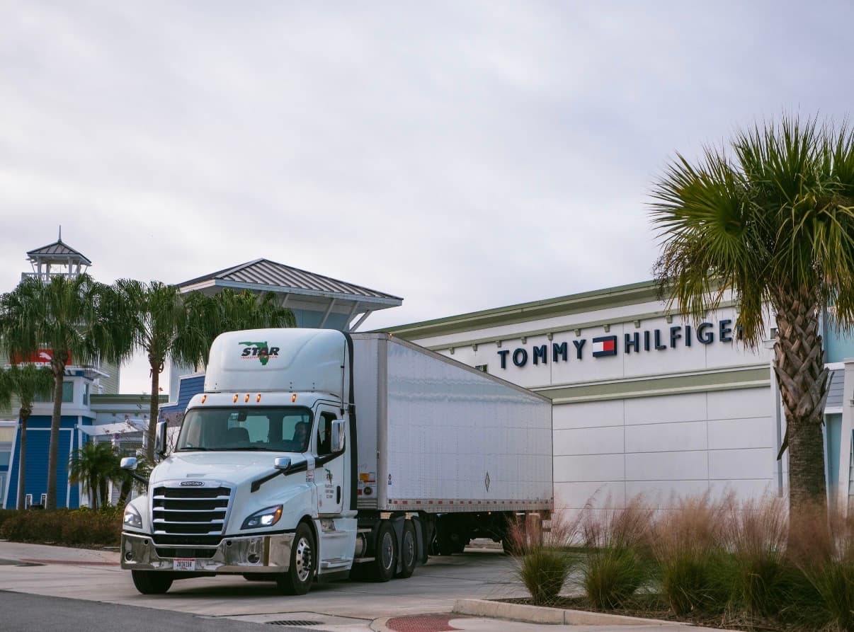 Semi-truck making a direct store delivery at a retail location.