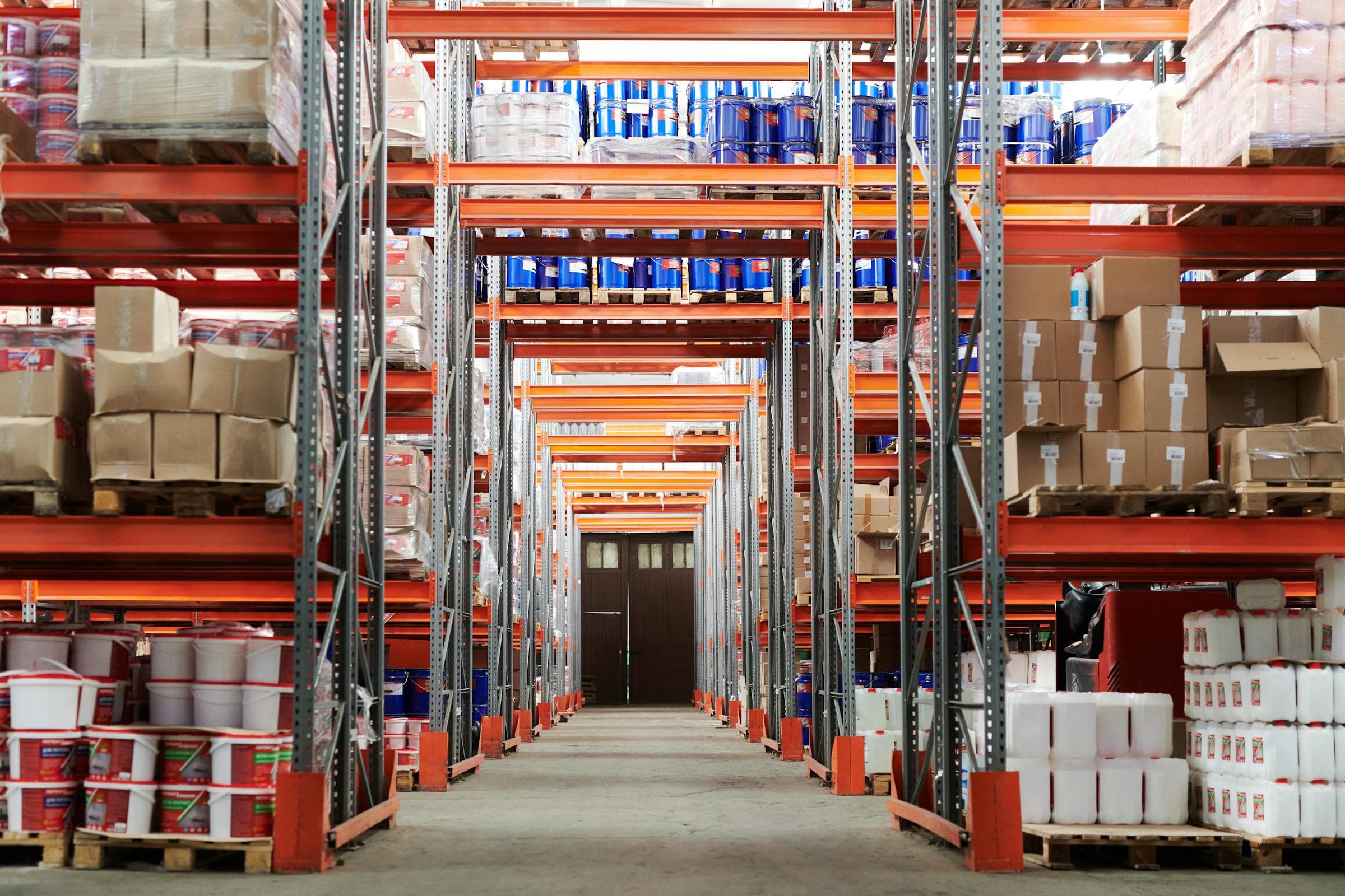 Warehouse aisle with industrial racking, cartons, and products organized for consolidation.